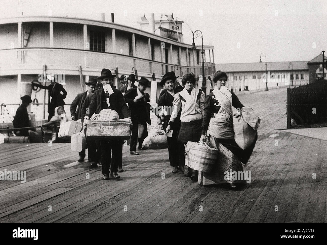 Immigrants to the USA landing at Ellis Island, New York, c1900. Artist: Unknown Stock Photo