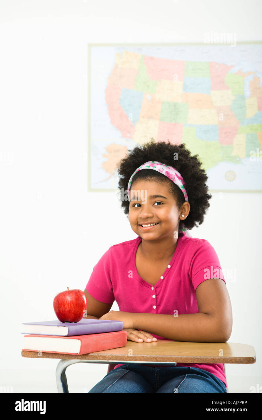 African American girl sitting in school desk smiling at viewer Stock ...