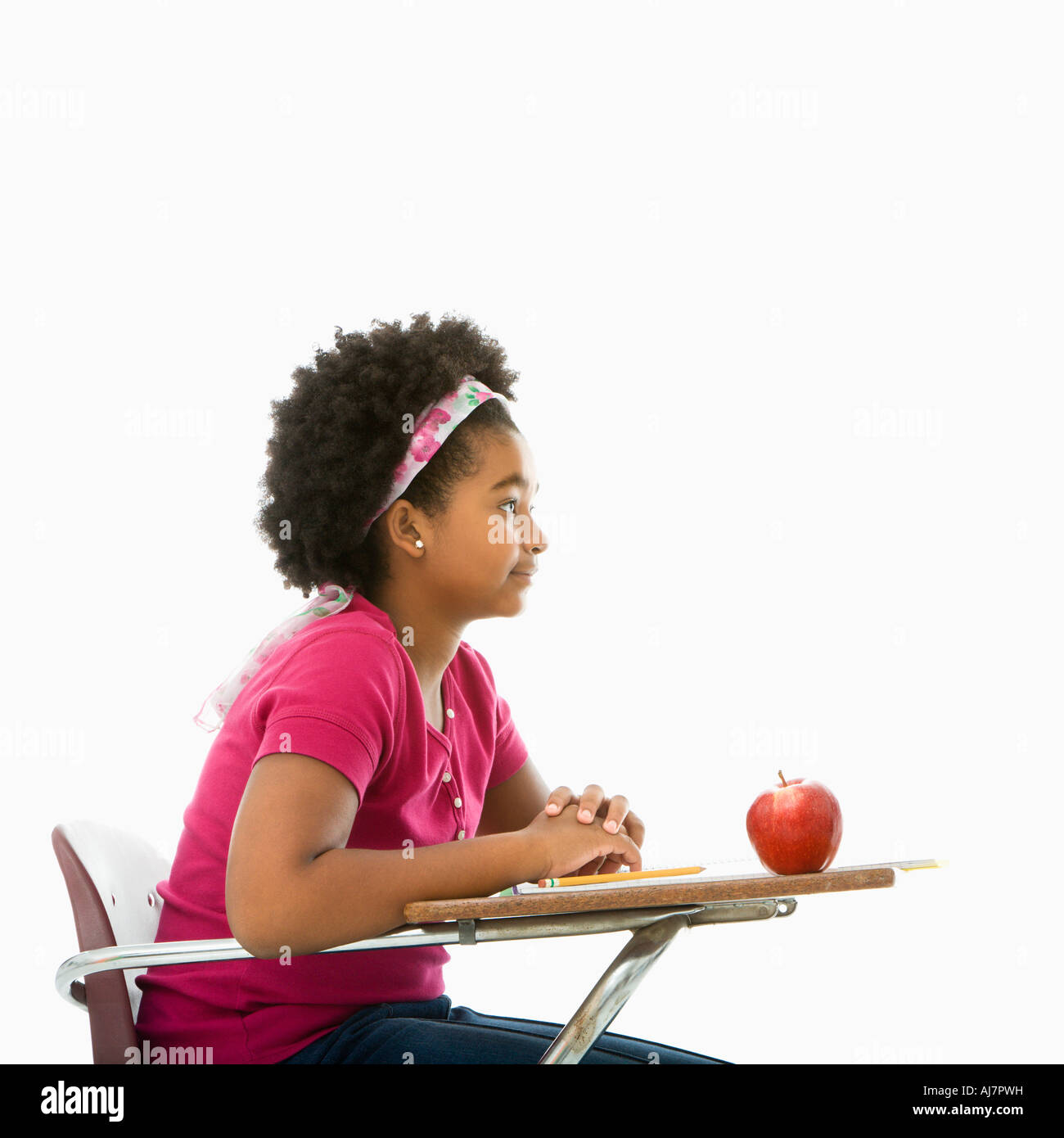 Side view of African American girl sitting in school desk Stock Photo ...