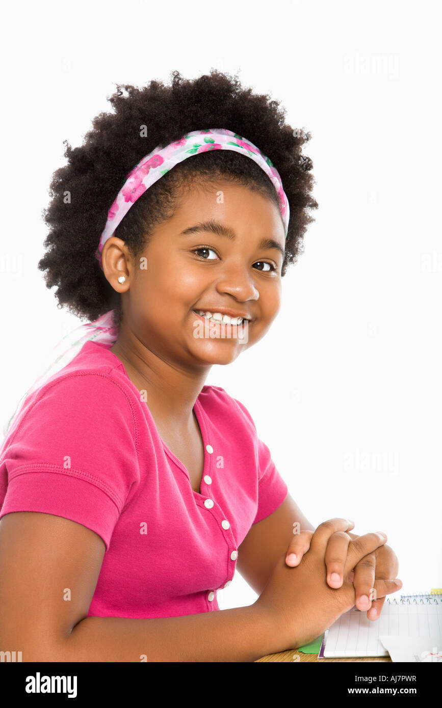 African American girl sitting in school desk smiling at viewer Stock ...