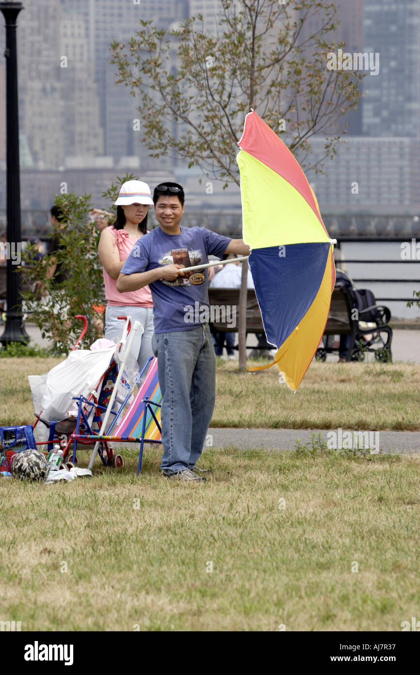 Asian Woman flying a kite at Asian Kite Festival in Liberty State Park NJ Stock Photo