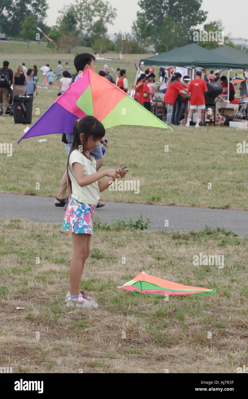 Young Asian girl flying a kite at Asian Kite Festival in Liberty State Park NJ Stock Photo