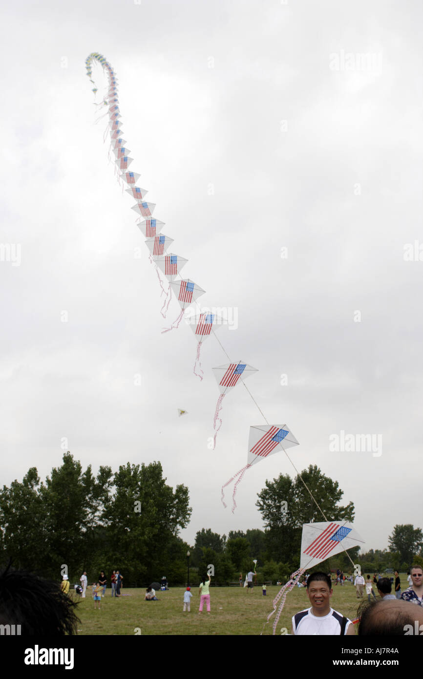 American flag kites reach into the sky on a cloudy day at Asian Kite Festival in Liberty State Park New Jersey Stock Photo