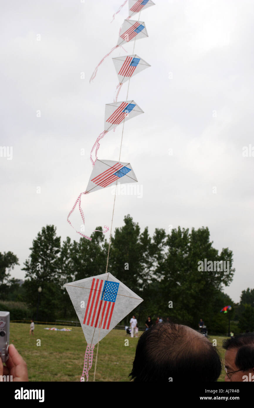 American flag kites reach into the sky on a cloudy day at Asian Kite Festival in Liberty State Park New Jersey Stock Photo