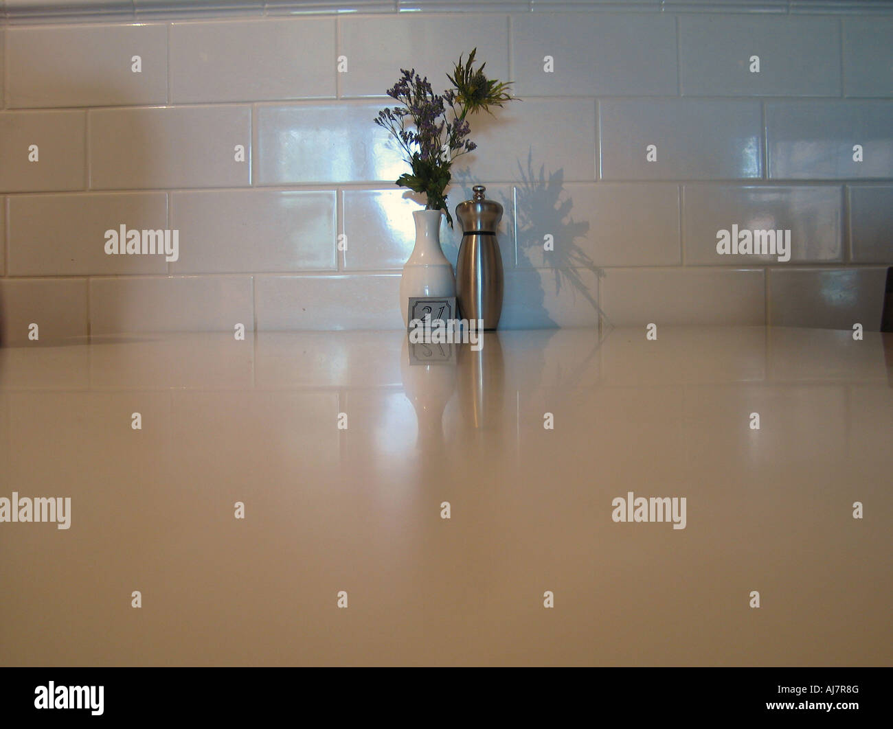 Peppermill on restaurant table with flowers Stock Photo