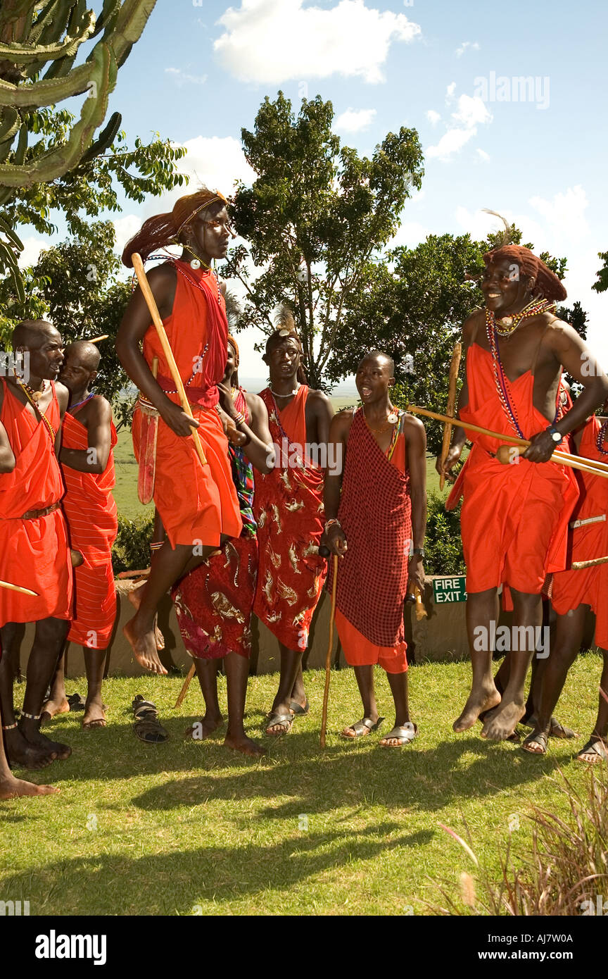 AFRICA KENYA Masai Mara Maasi men in traditional dress jumping dancing Stock Photo