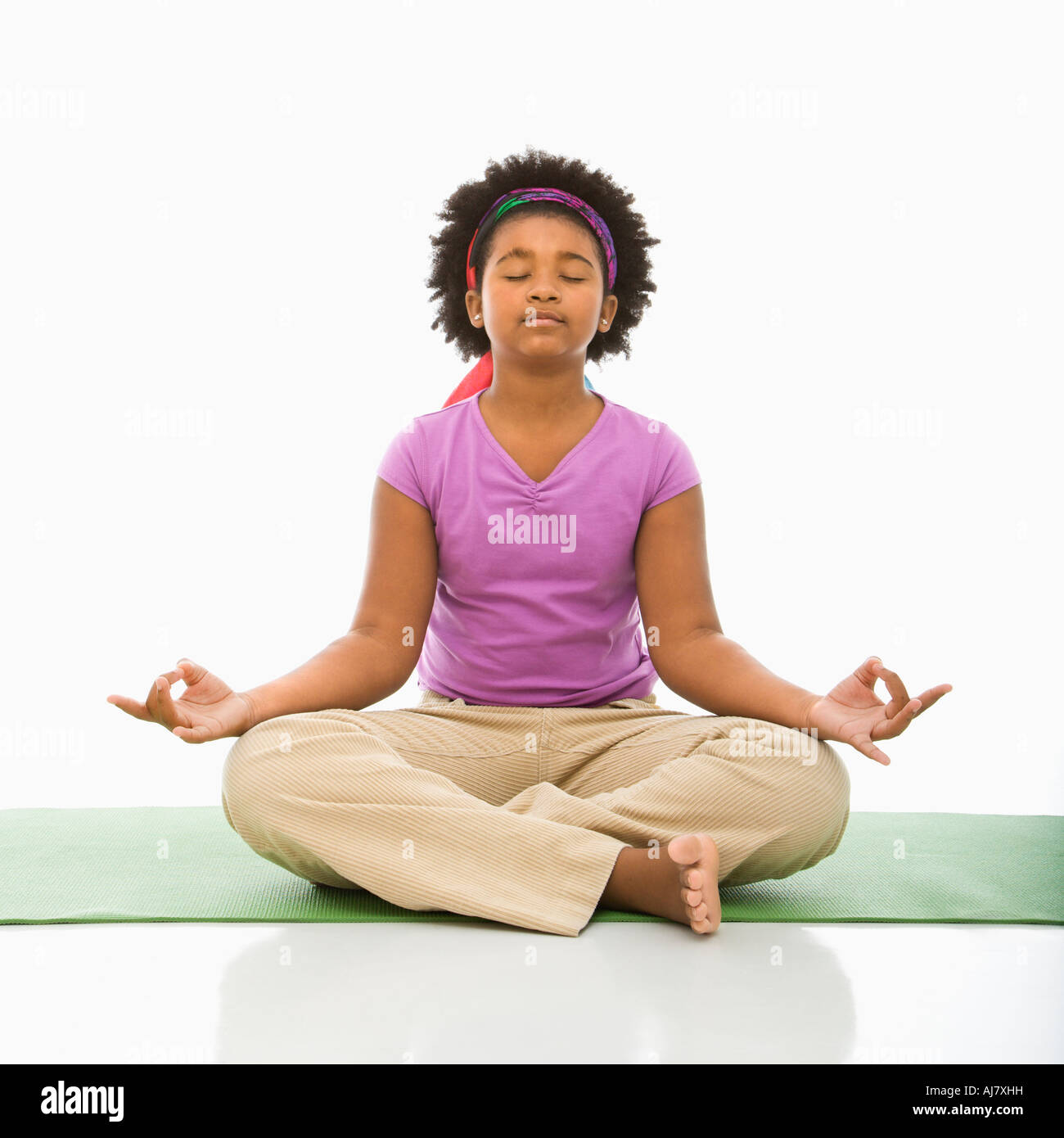 African American girl sitting on floor in yoga lotus posture with eyes closed Stock Photo Alamy