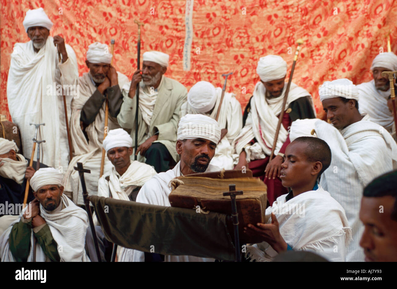Priests with an ancient bible at a service at the Bet Maryam (Church of the Virgin Mary), Lalibela, Ethiopia Stock Photo