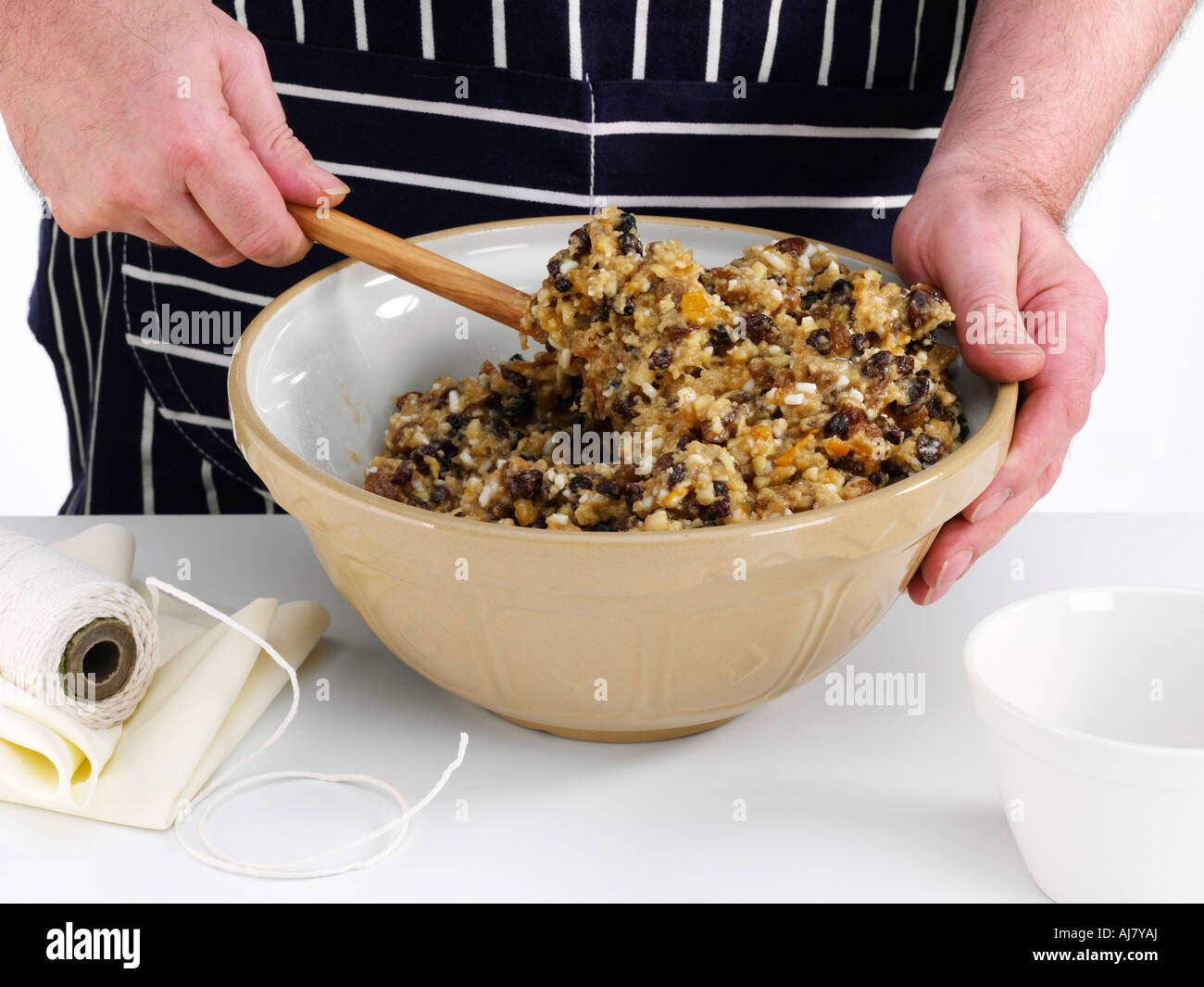 Mixing the ingredients for a traditional Christmas pudding in a large