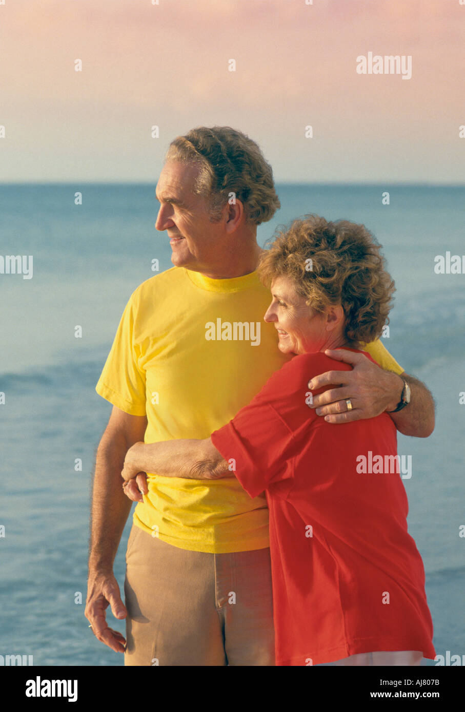 Mature couple embracing on beach Stock Photo