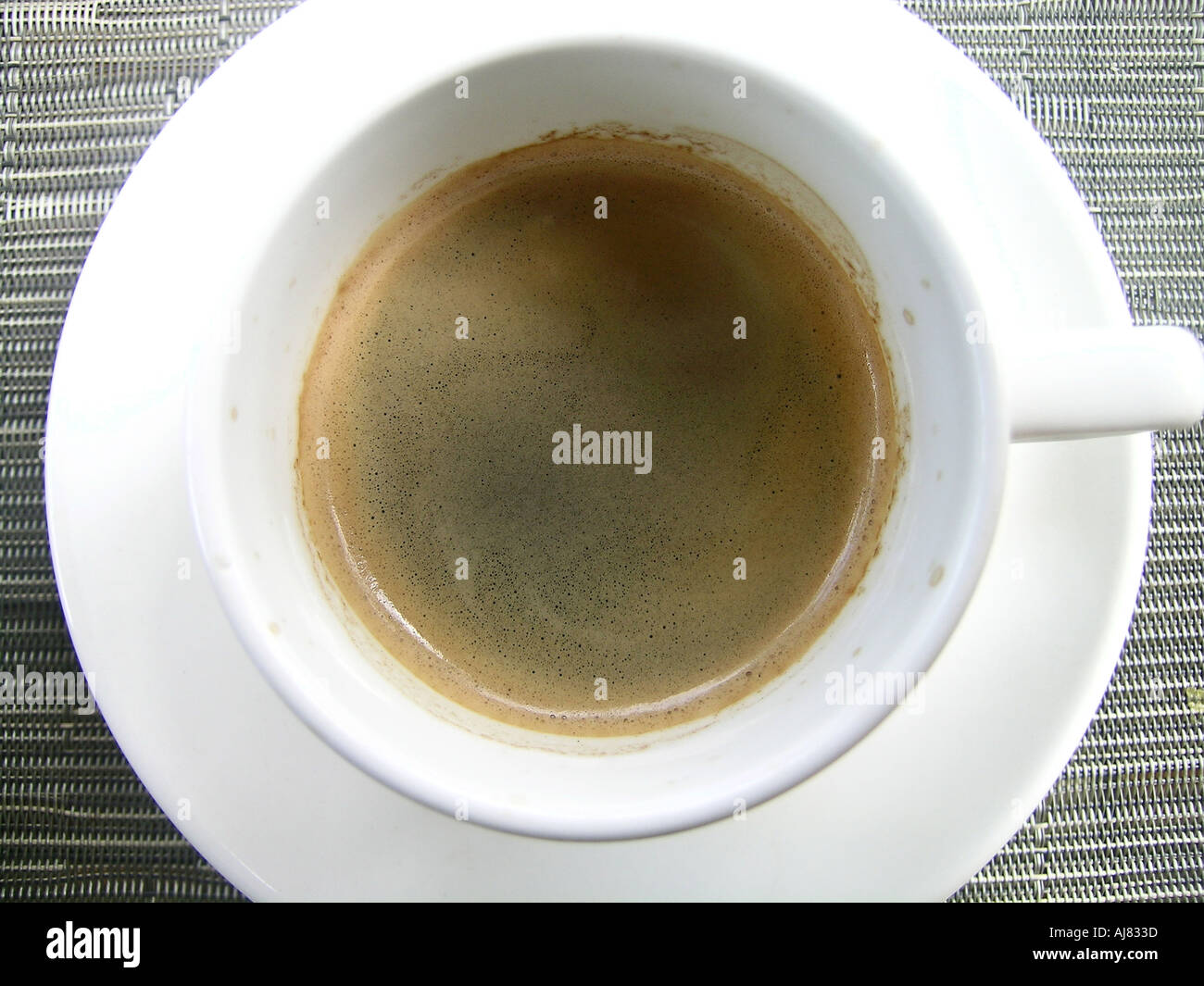 Overhead view of cup of black espresso coffee & saucer on bar Stock Photo