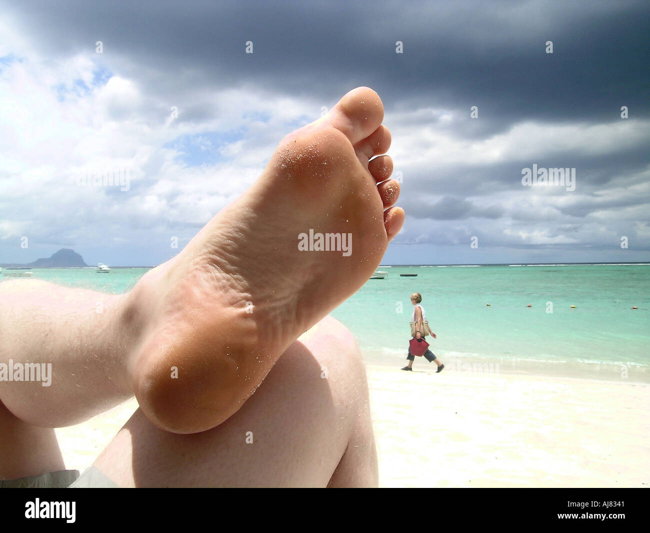 Sole of man's foot at beach Stock Photo