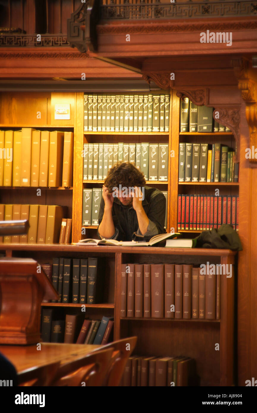 Man reading and studying in the main reading room at the New York Public Library in Midtown Manhattan New York NY Stock Photo