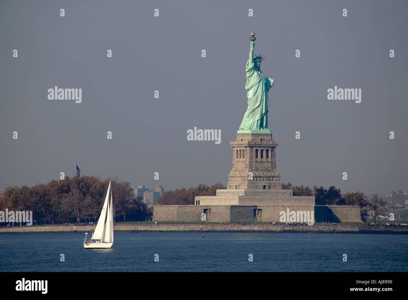 Sailboat on the Hudson River with Statue of Liberty in background New York NY Stock Photo