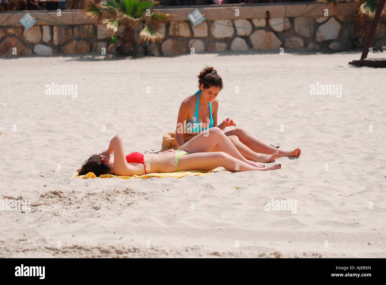 Israel Tel Aviv woman sunbathing on the beach Stock Photo