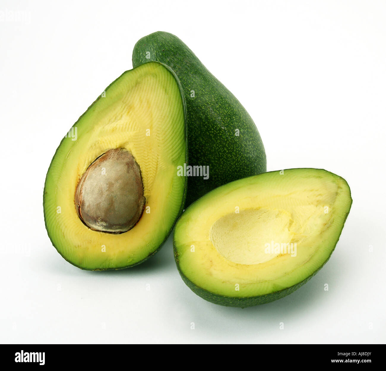 a cut and a whole avocado on white background Stock Photo - Alamy