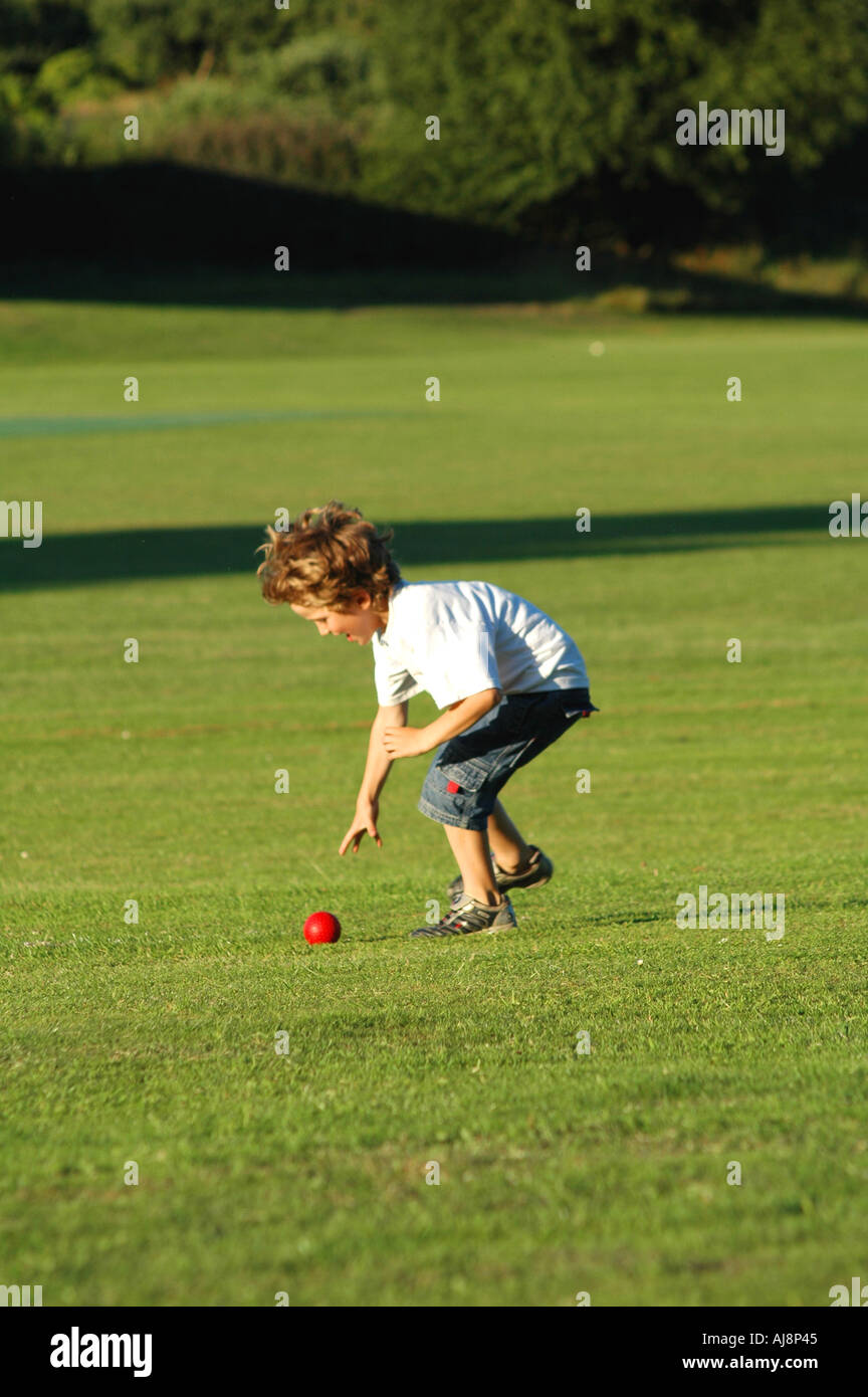 Child picking up cricket ball hires stock photography and images Alamy