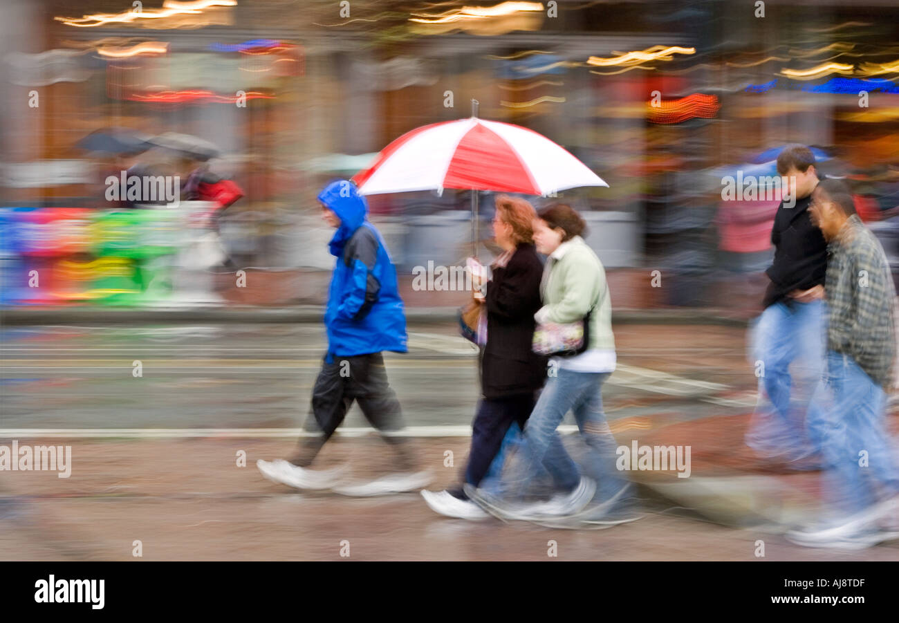 People crossing the street with umbrellas in a rainy day Stock Photo ...