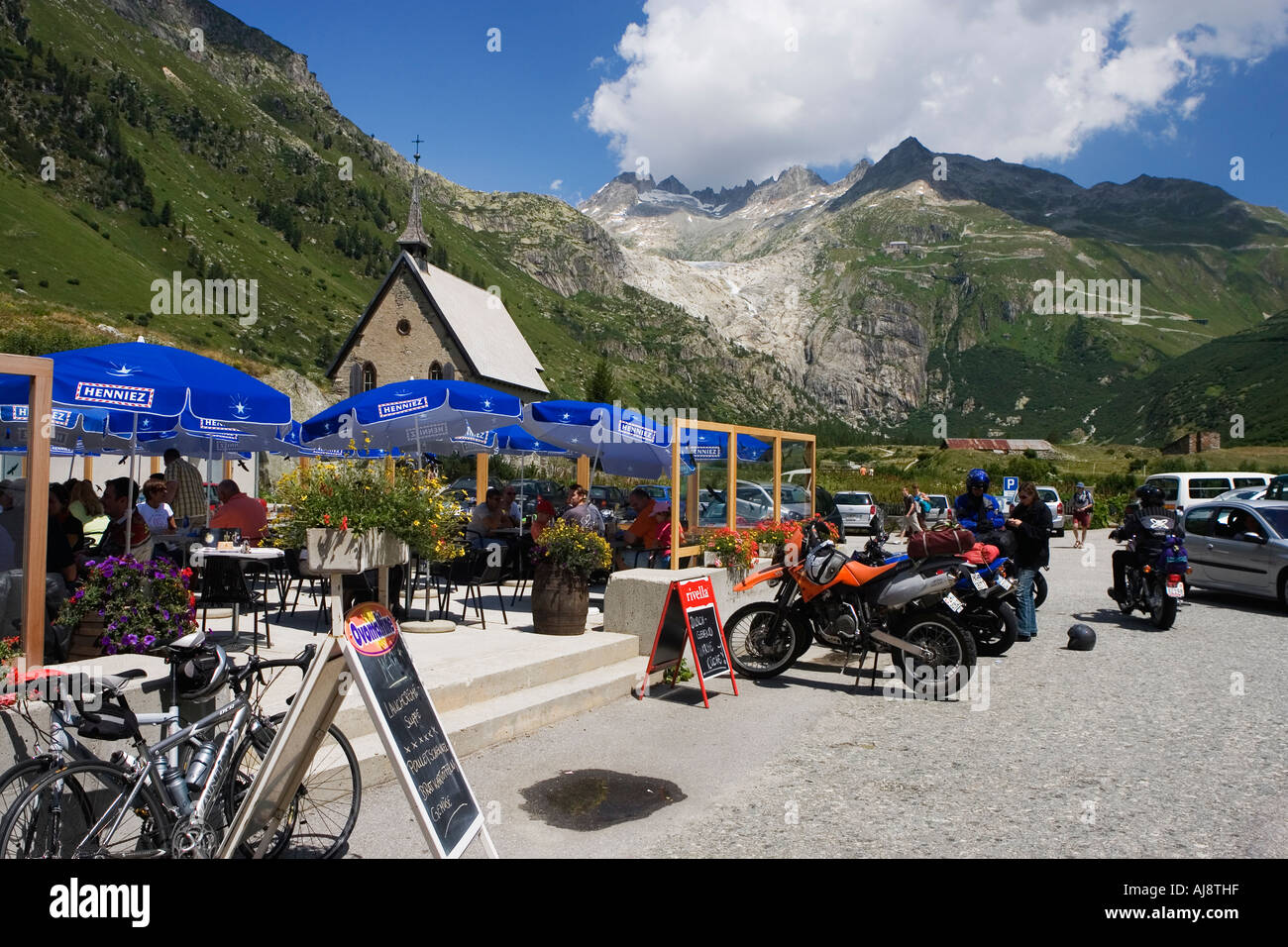 Cafe terrace at the Hotel Glacier du Rhone and the Rhone Glacier in the background Gletsch Wallis Switzerland July 2006 Stock Photo