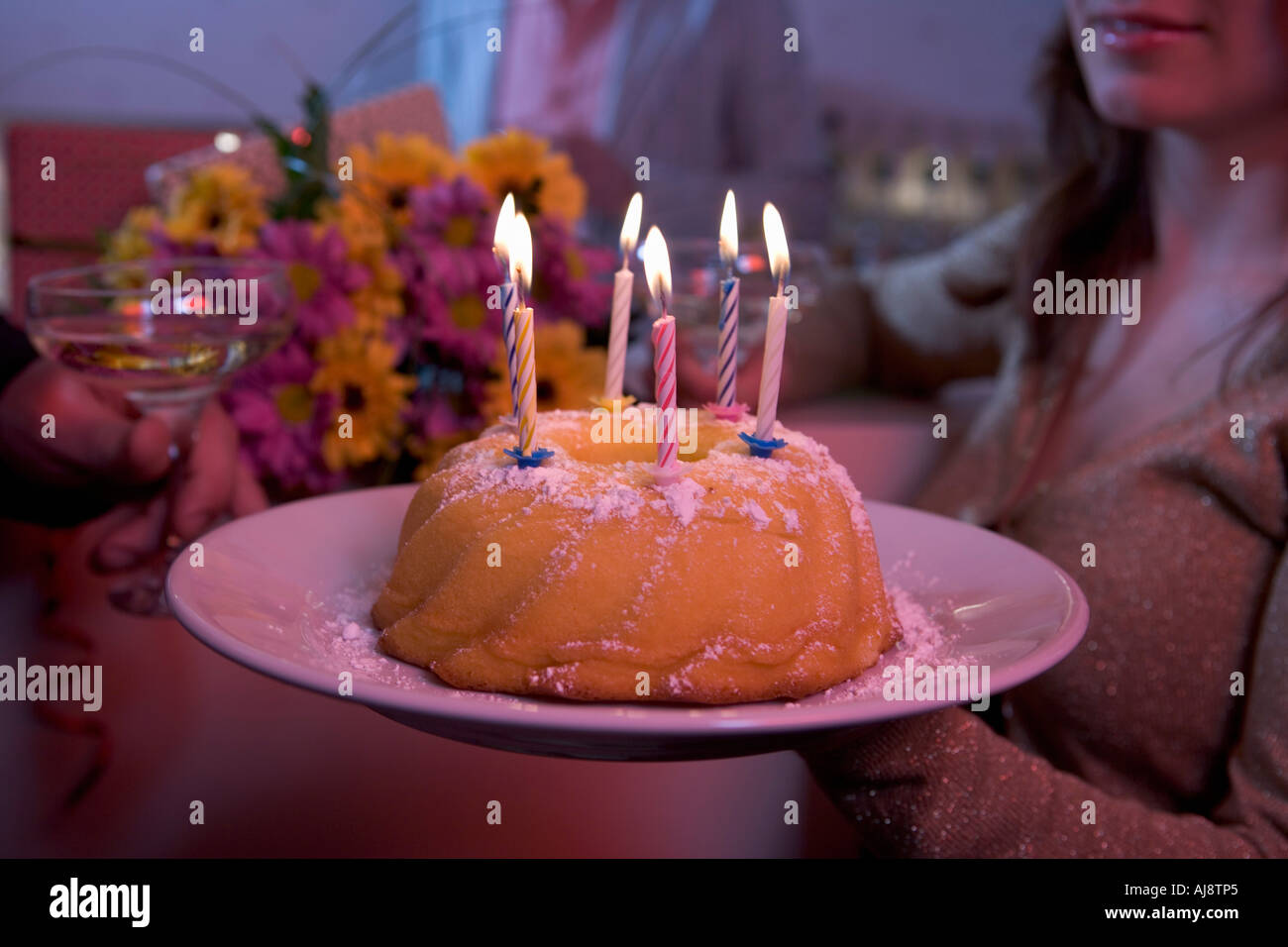 Woman holding birthday cake with candles Stock Photo - Alamy
