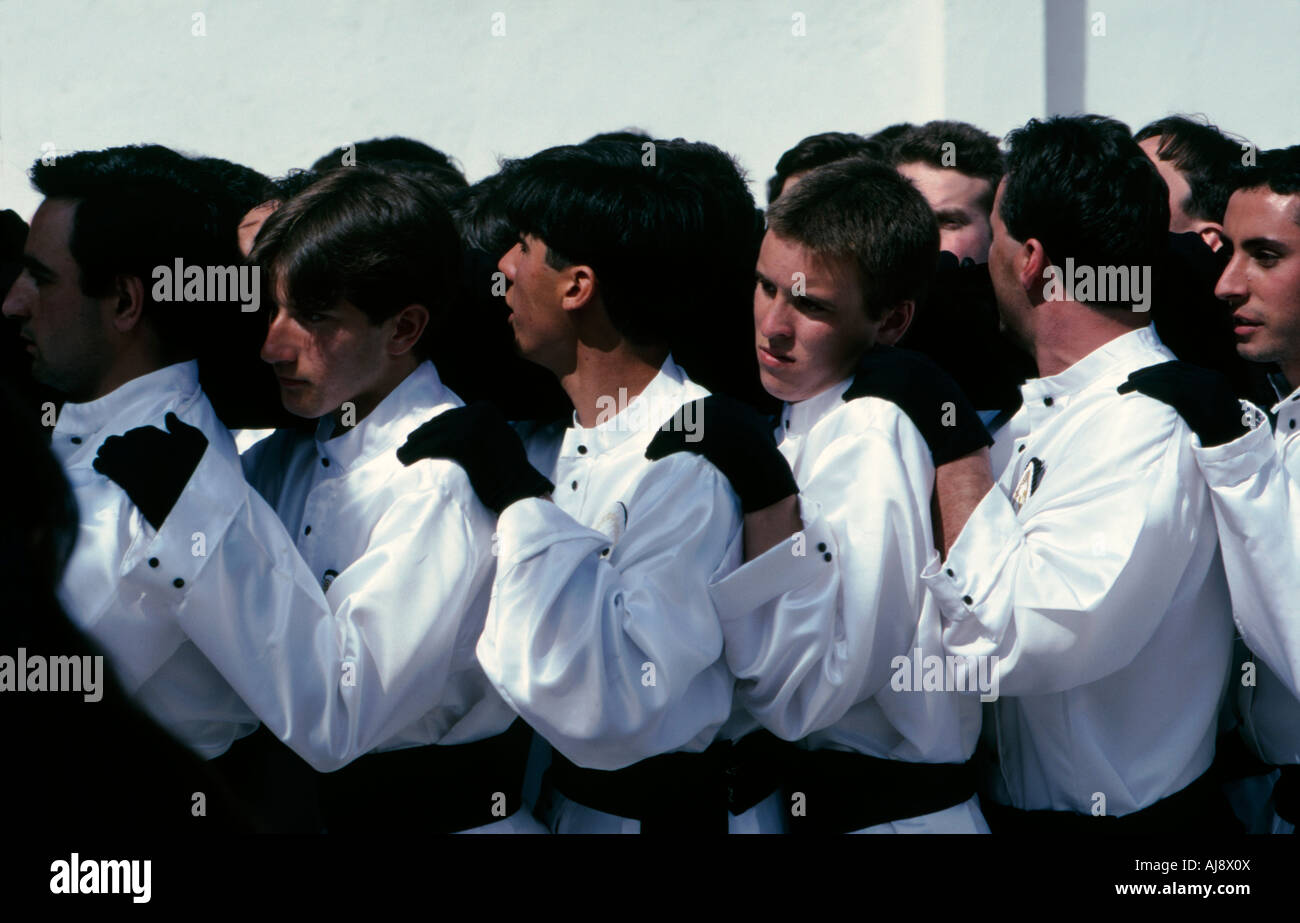 Member of a religious fraternity carrying an huge effigy of Christ ...