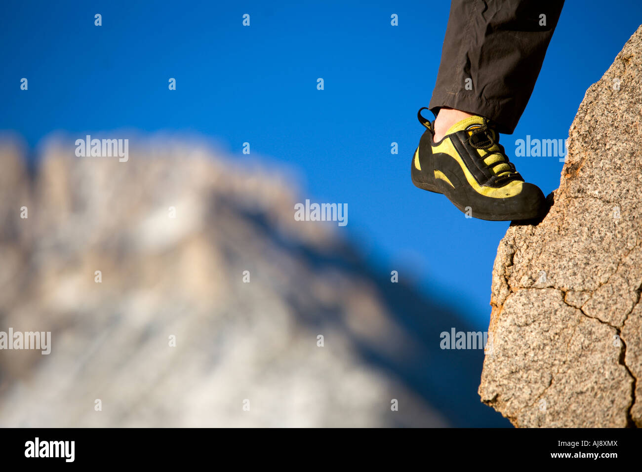 A climber's foot in a shoe on a foothold Stock Photo