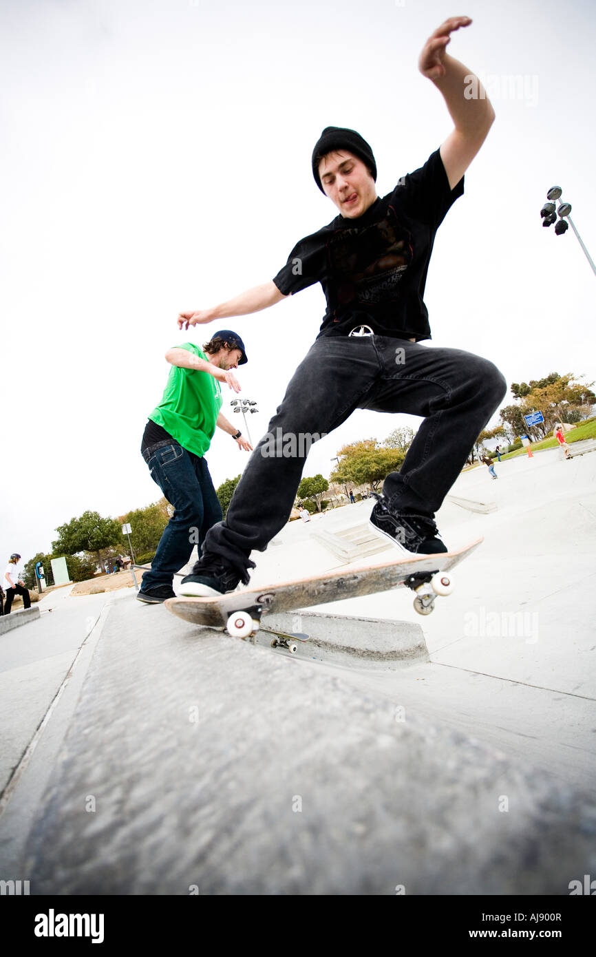 Two skateboarders do tricks at a skatepark Stock Photo Alamy