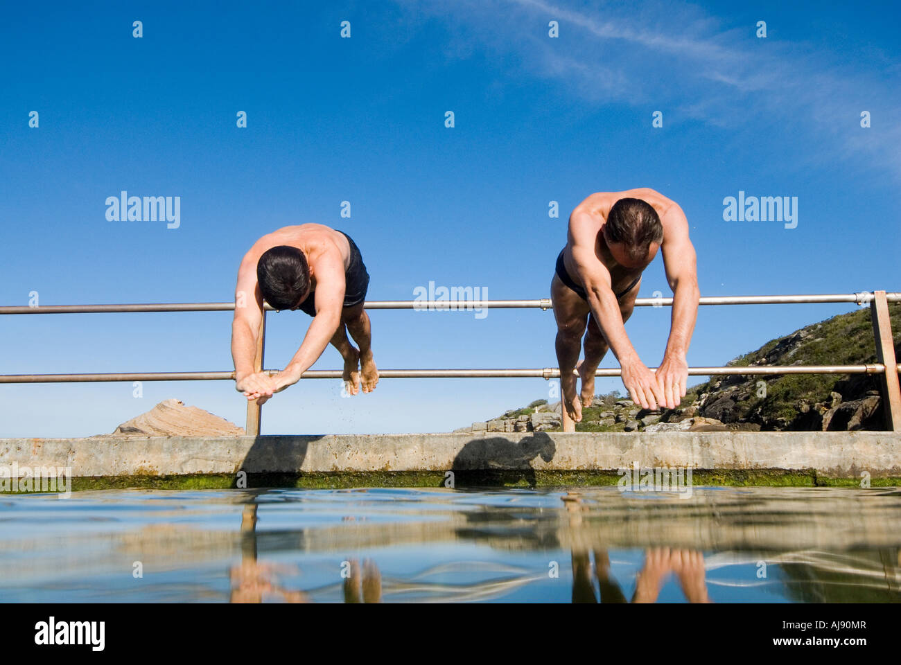 Two men jumping swimming pool hi-res stock photography and images - Alamy