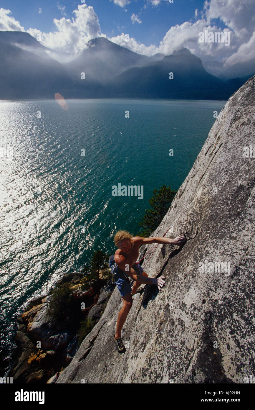 Man rock climbing above water, Canada Stock Photo Alamy