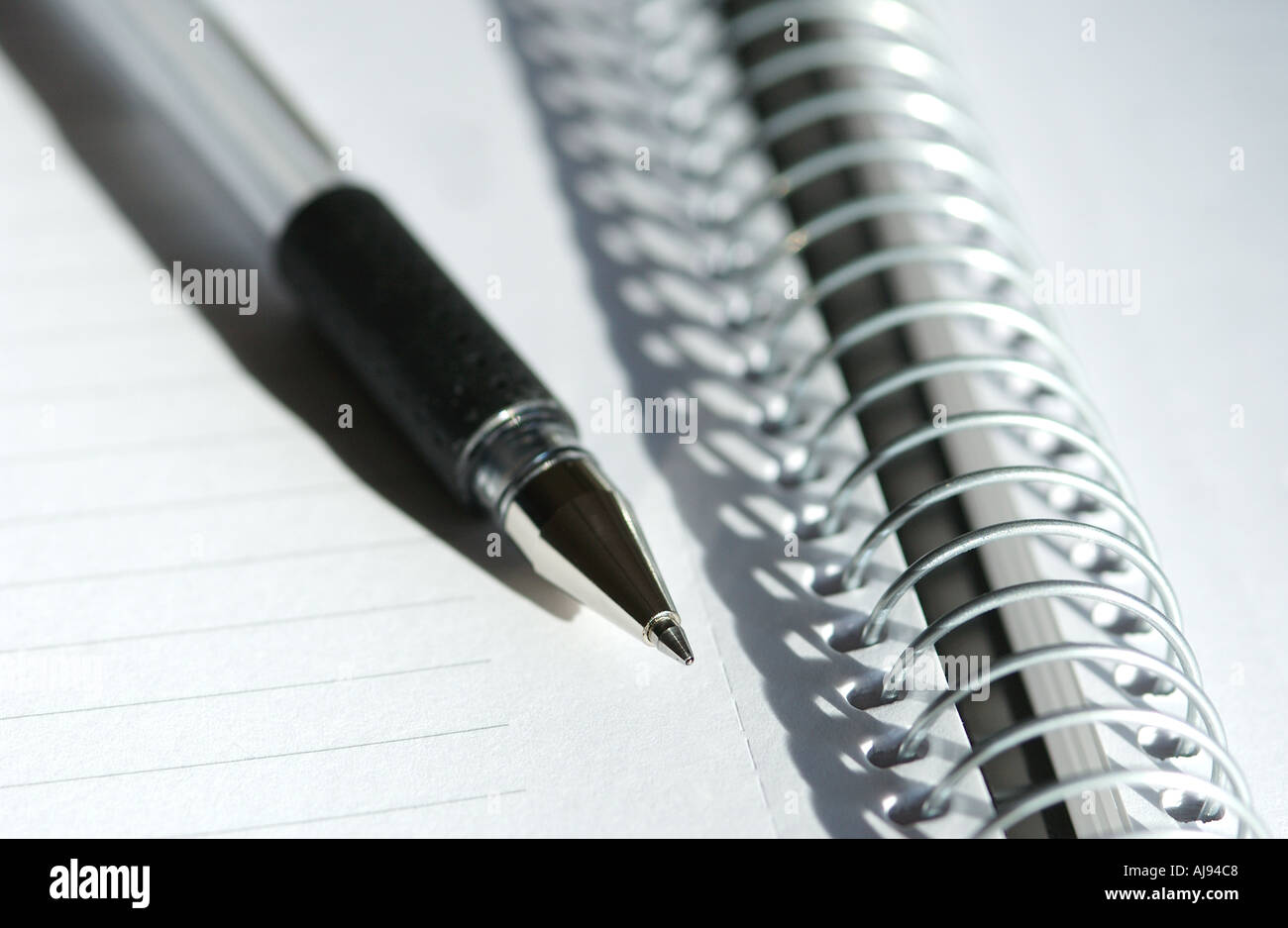 Close up of Spiral note pad notebook and pen Stock Photo
