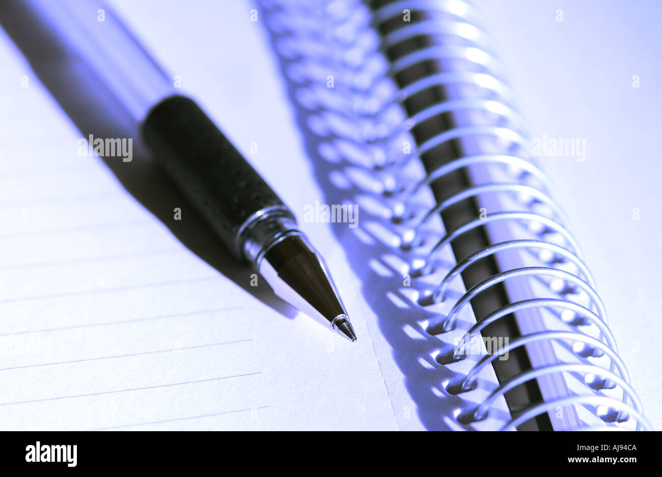 Close up of Spiral note pad notebook and pen Stock Photo