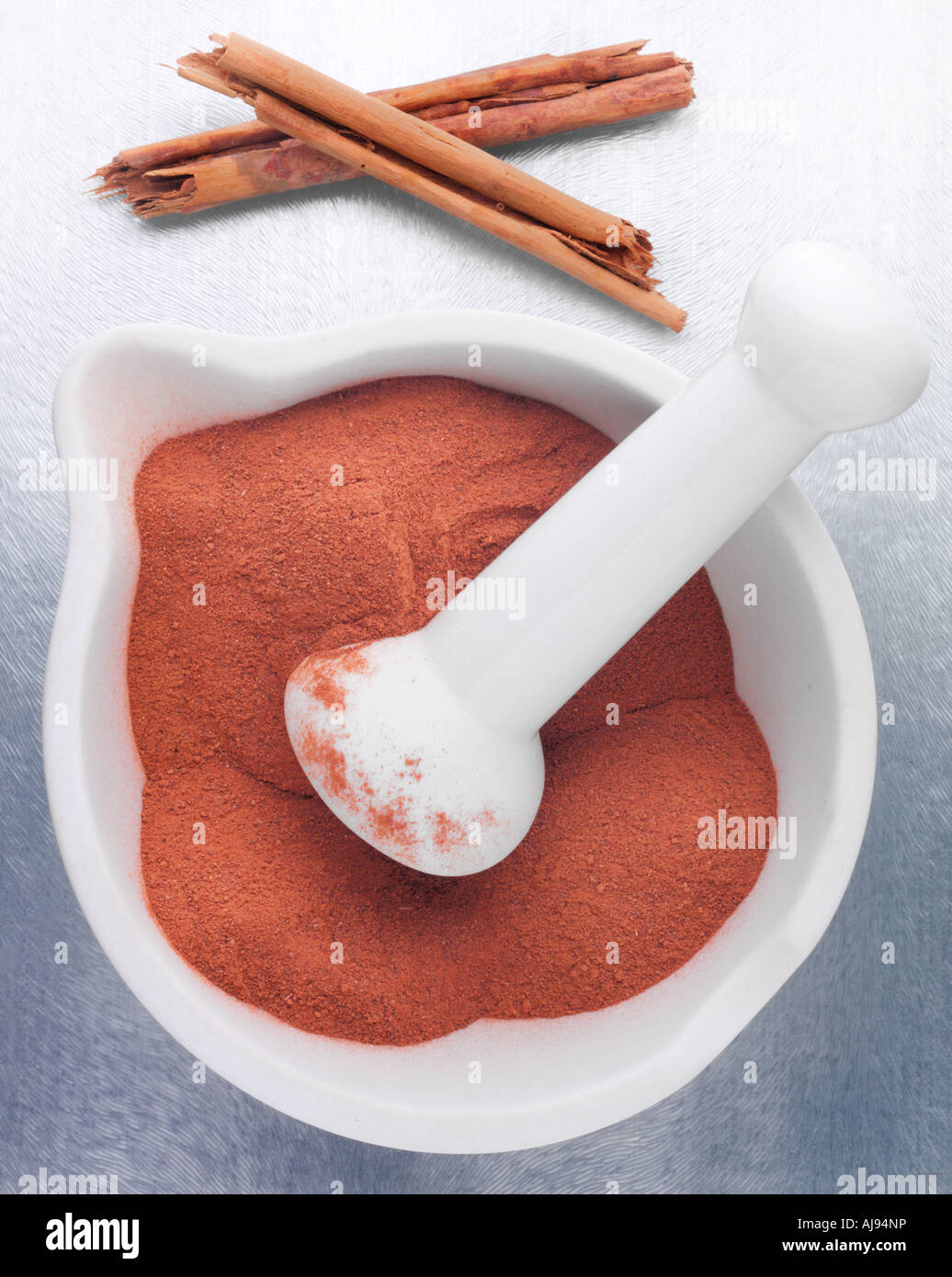 CINNAMON STICKS WITH GROUND CINNAMON IN PESTLE AND MORTAR Stock Photo Alamy