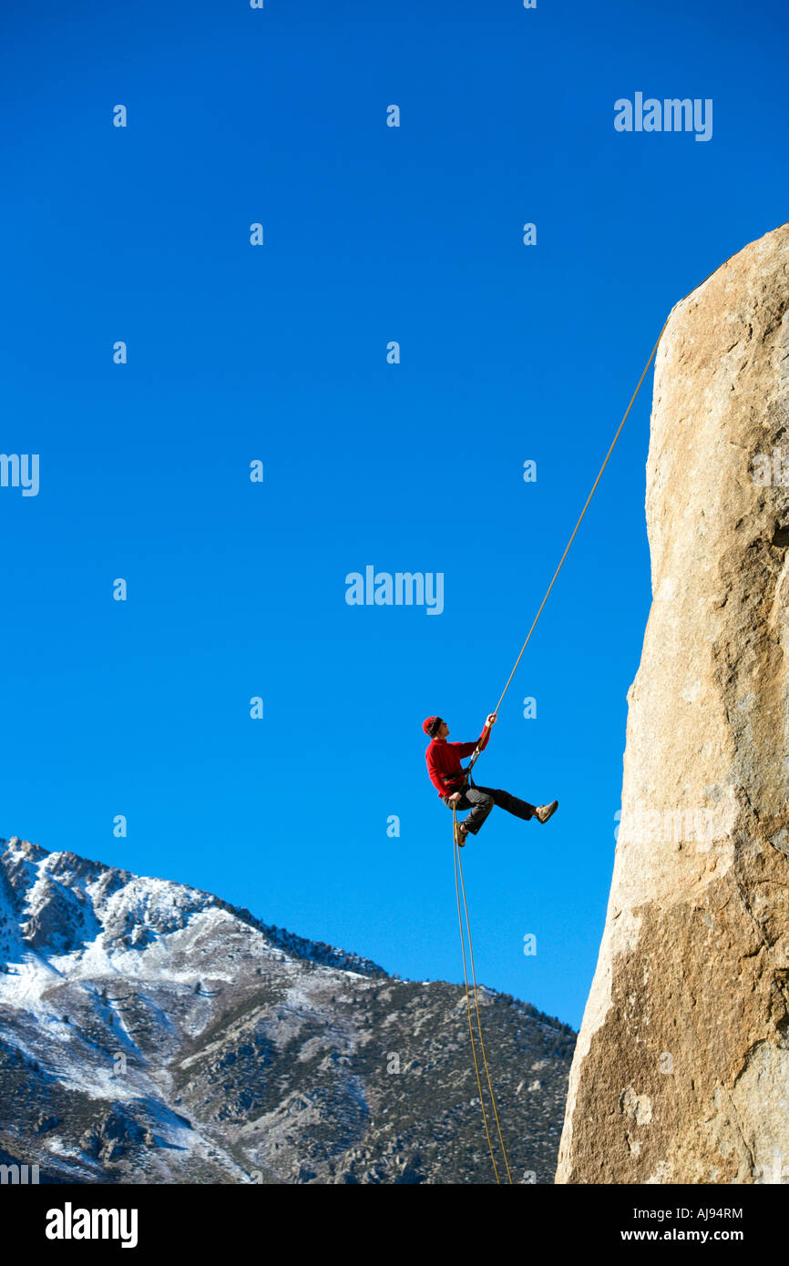 Climber rappelling down boulder Stock Photo Alamy