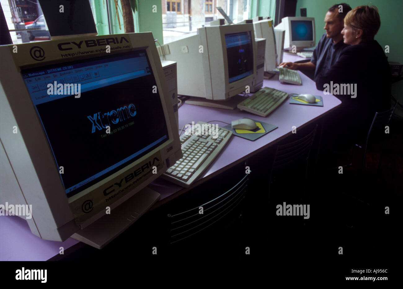 Computer monitors at an Internet cafe in London, UK. Stock Photo