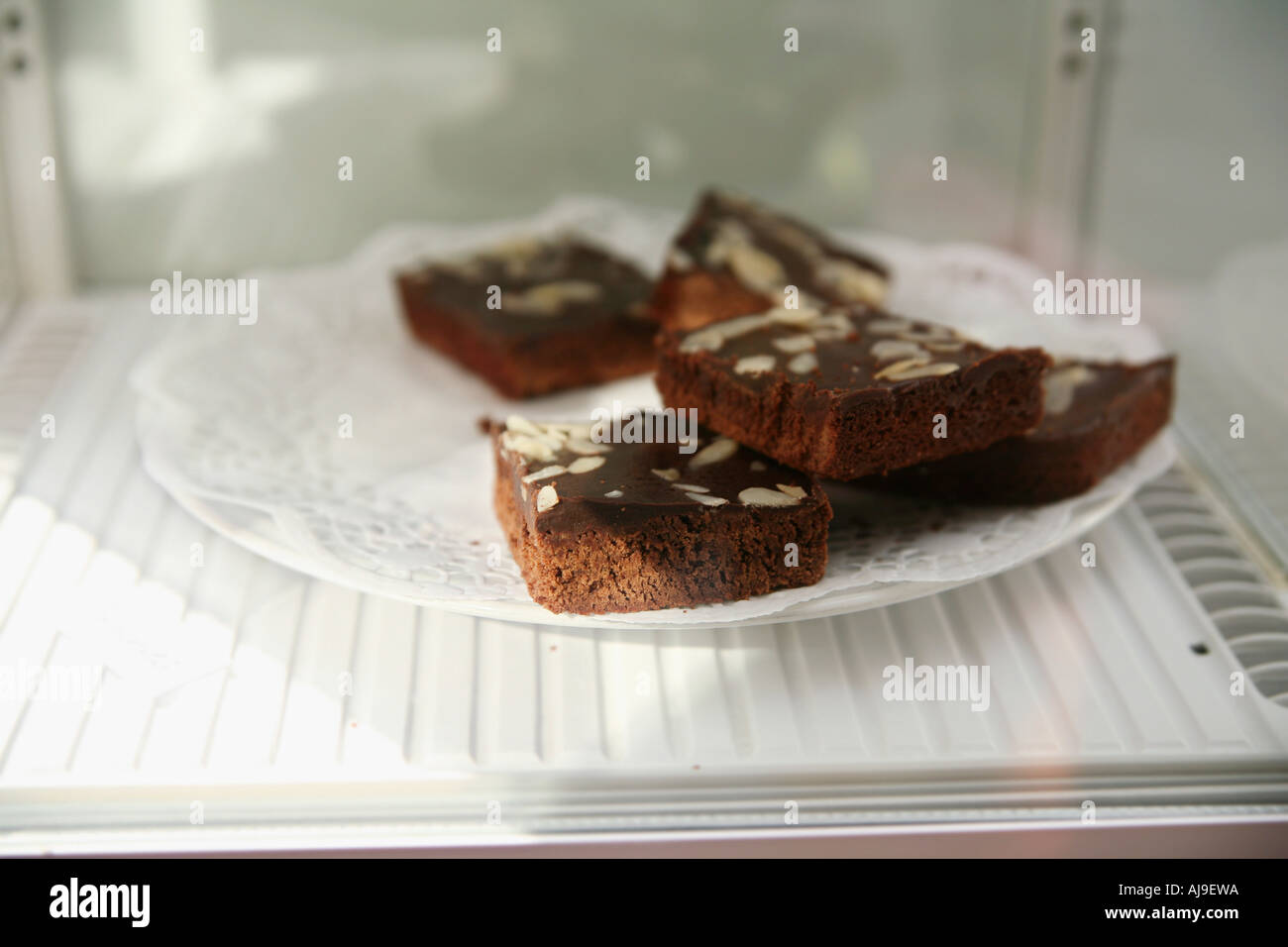 Plate of brownies in refrigerator Stock Photo
