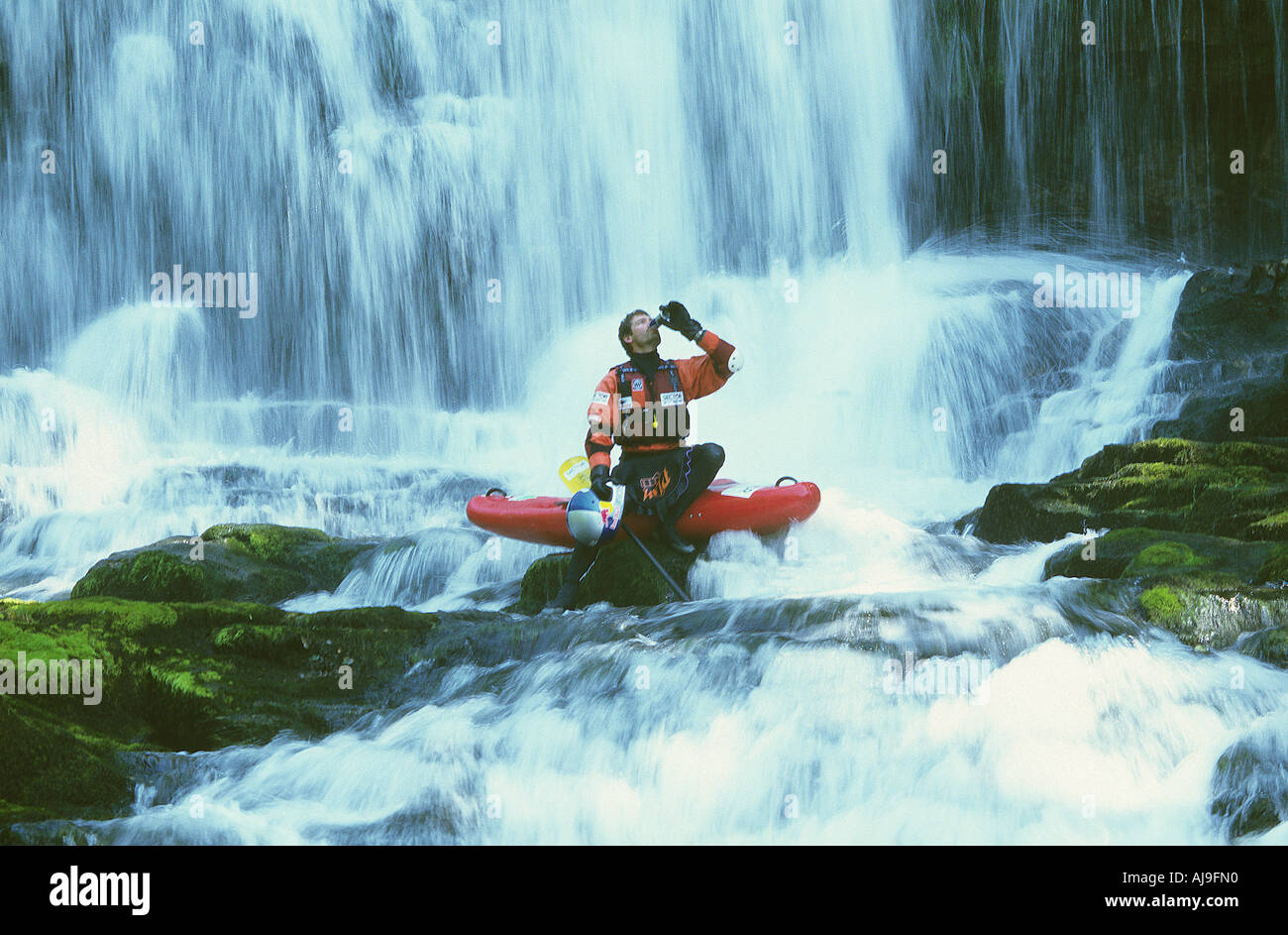 Shaun Baker rehydrating during an extreme kayaking shoot Stock Photo