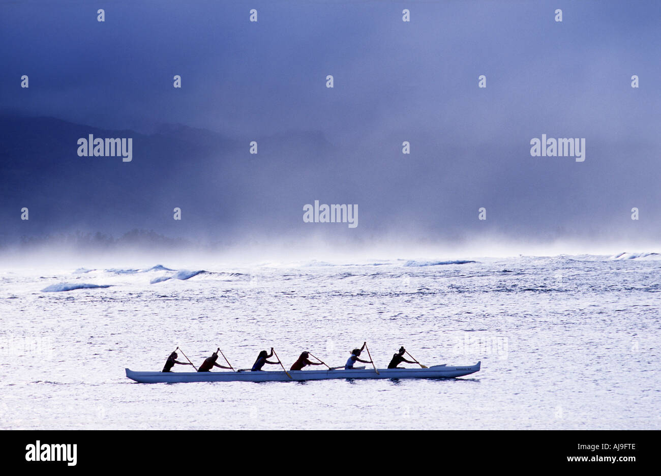 Women rowing a Polynesian canoe of the coast of Oahu Hawaii Stock Photo