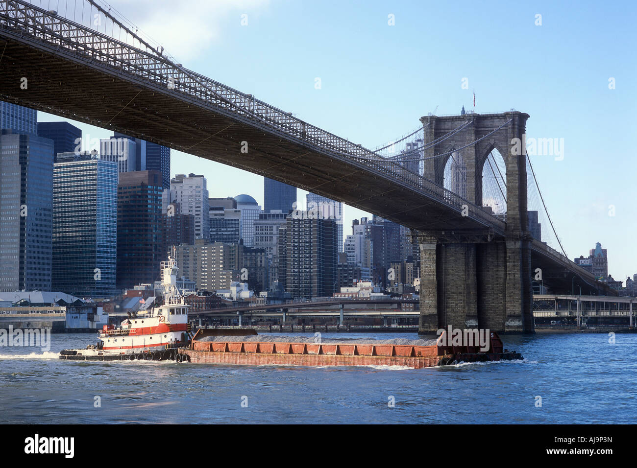 Barge Passing Under Brooklyn Bridge, New York City, New York, USA Stock