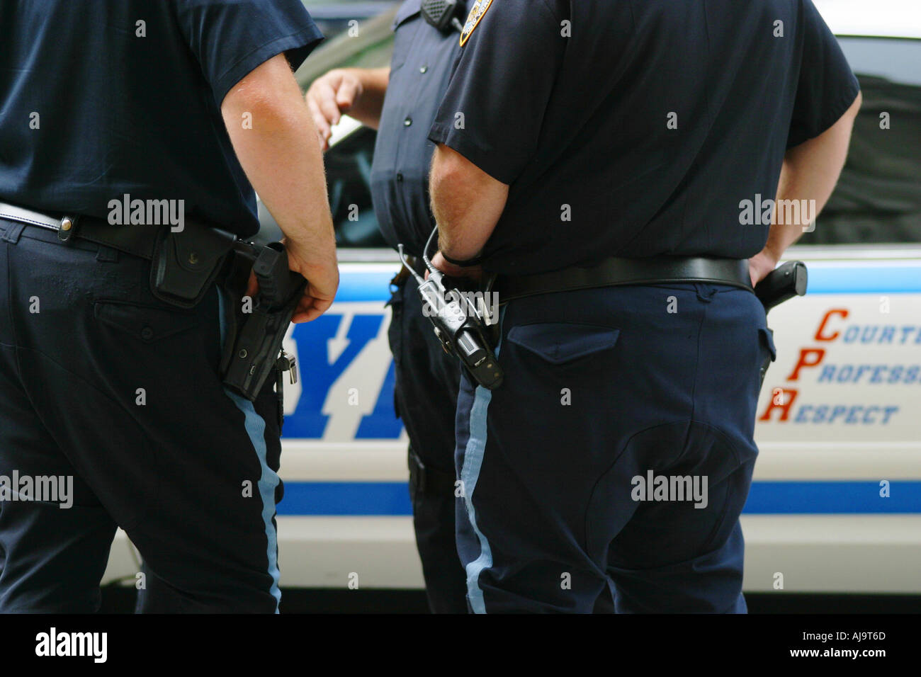NYPD police in uniform in front of patrol car NYC Stock Photo