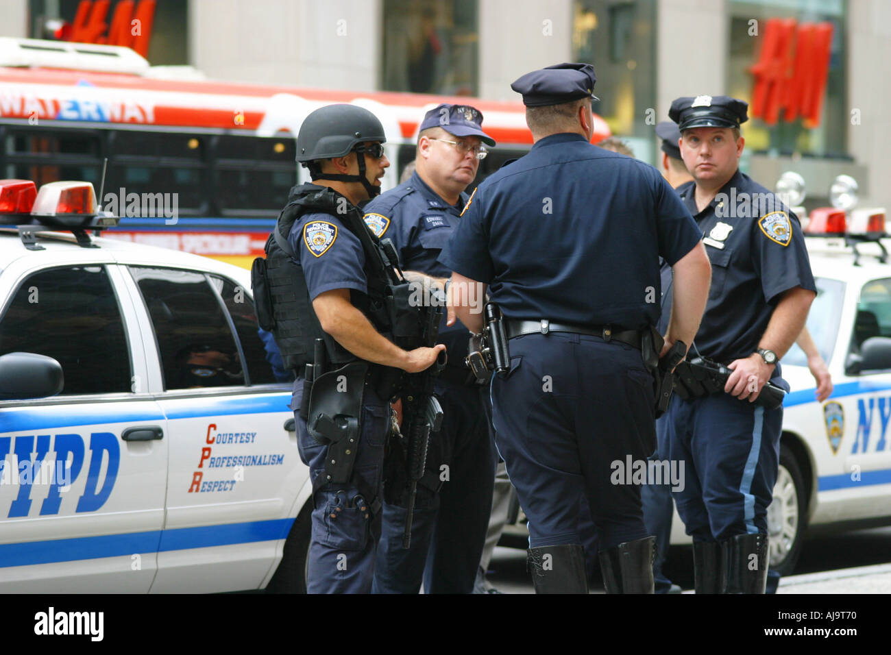 NYPD police in uniform in front of patrol car NYC Stock Photo - Alamy