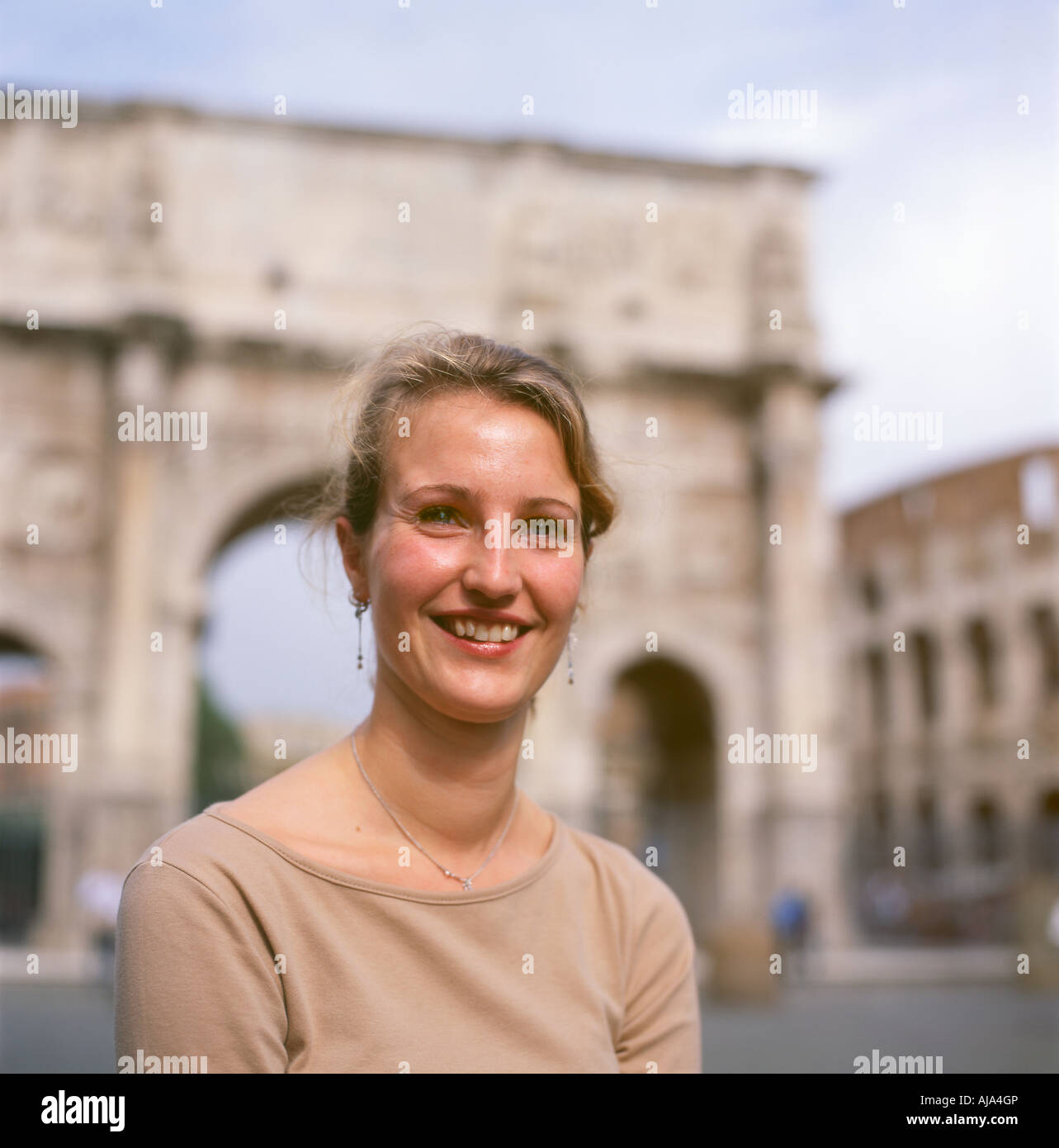 A beautiful Dutch woman tourist visitor smiling visiting the ancient city sites posing near the Colosseum in Rome Italy Europe EU  KATHY DEWITT Stock Photo