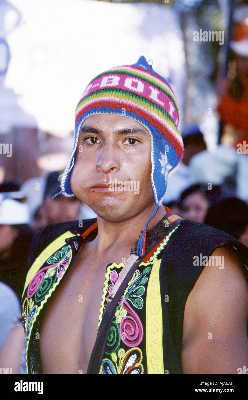 A young Bolivian man in traditional clothes with coca leaves in his mouth during the carnival festival in clisa, Cochabamba Stock Photo