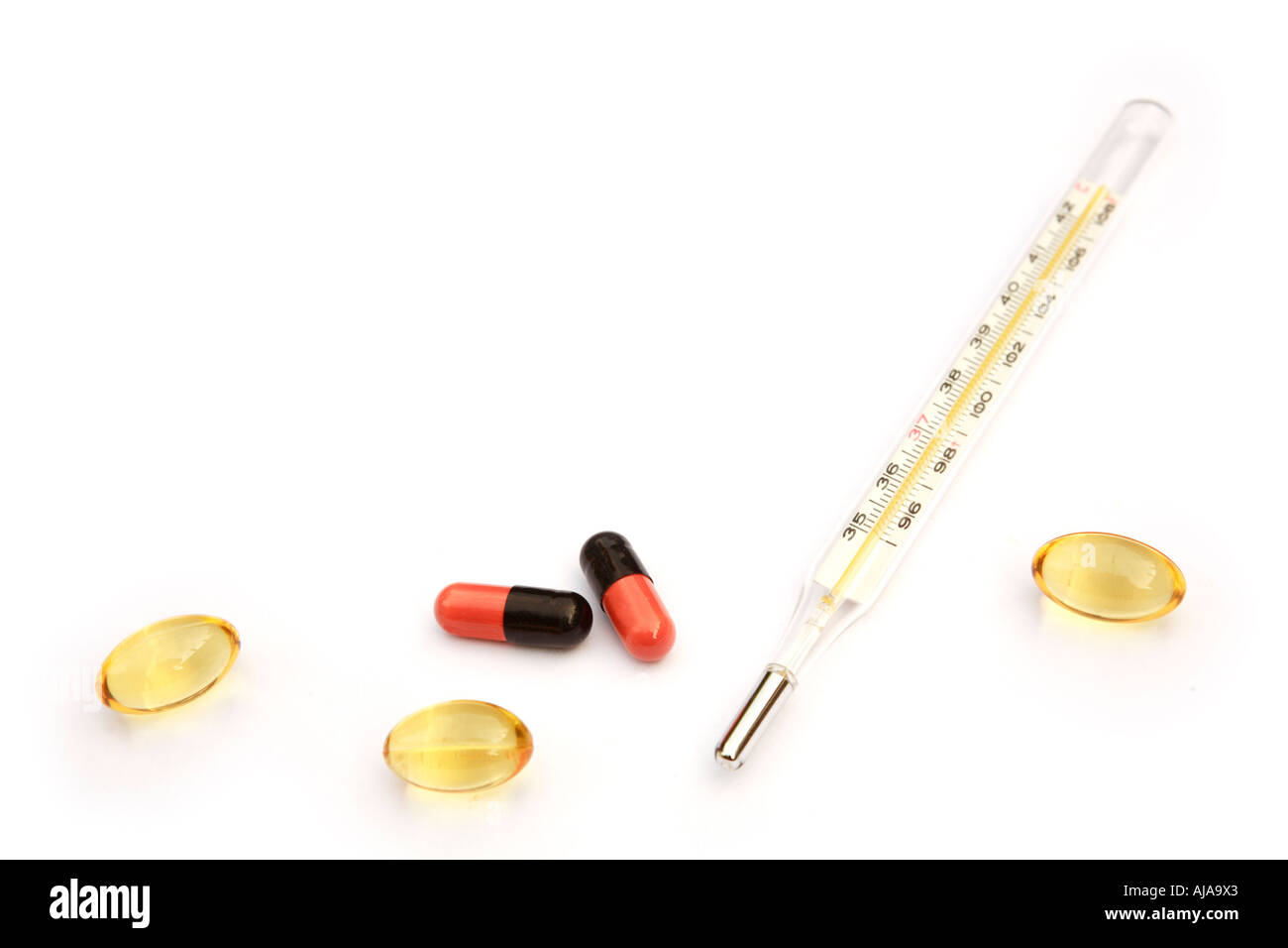 Thermometer and pills isolated against a white background with copy space Stock Photo