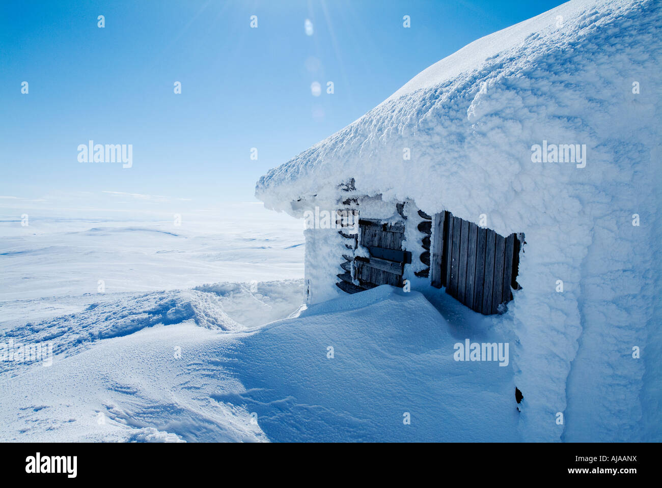 Snow ice covered wooden hut in Finland Stock Photo - Alamy