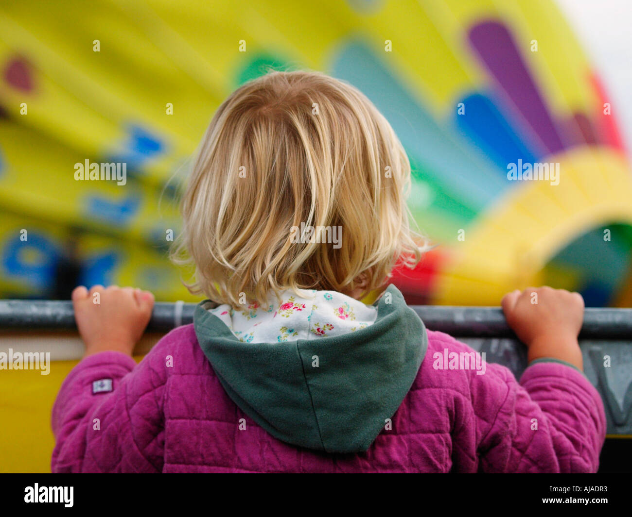 Little child watching hot air balloons being prepared for takeoff Breda ballonfiesta ballooning festival 2006 Stock Photo