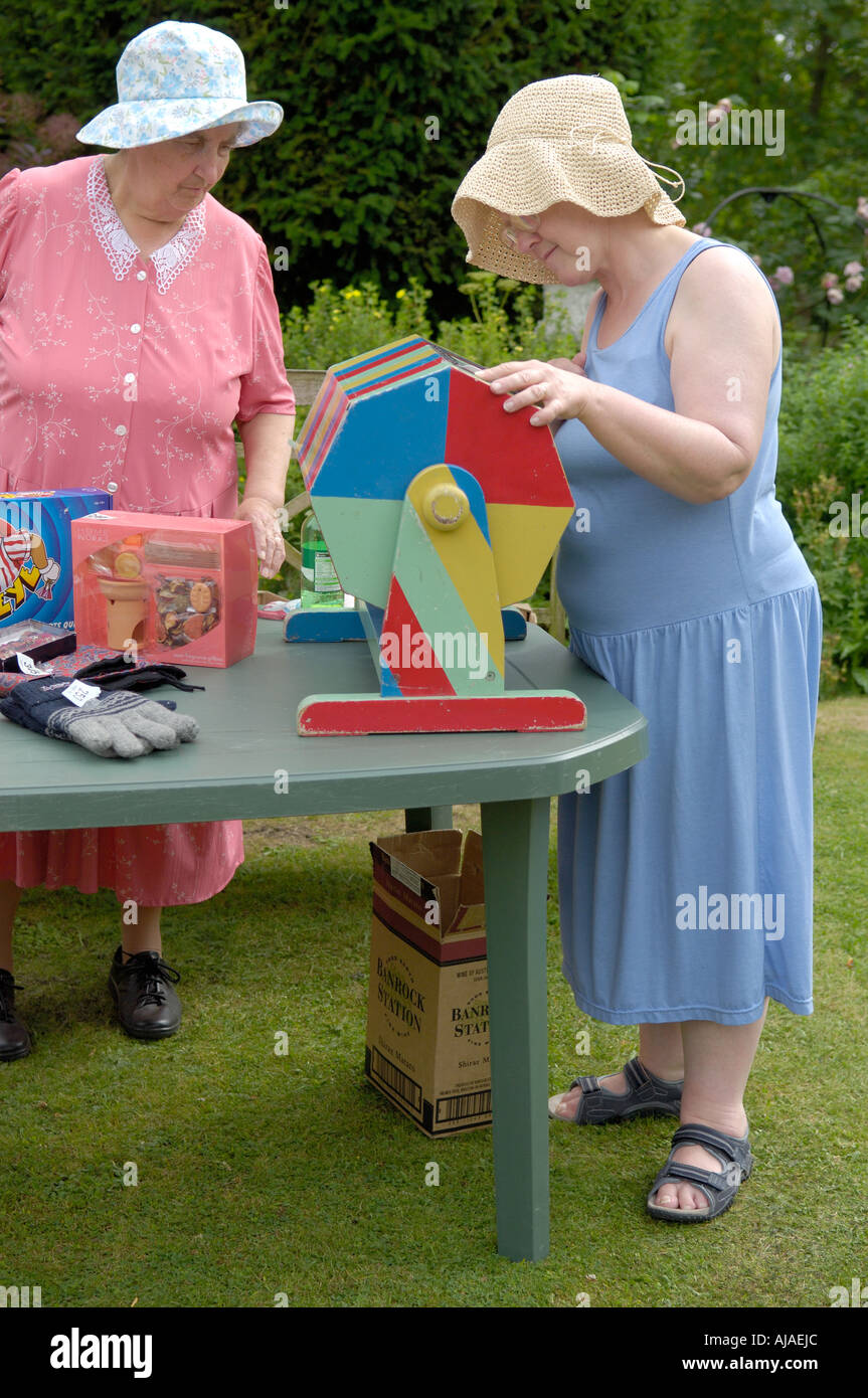 Women running a fete tombola stall, Oxfordshire, UK Stock Photo