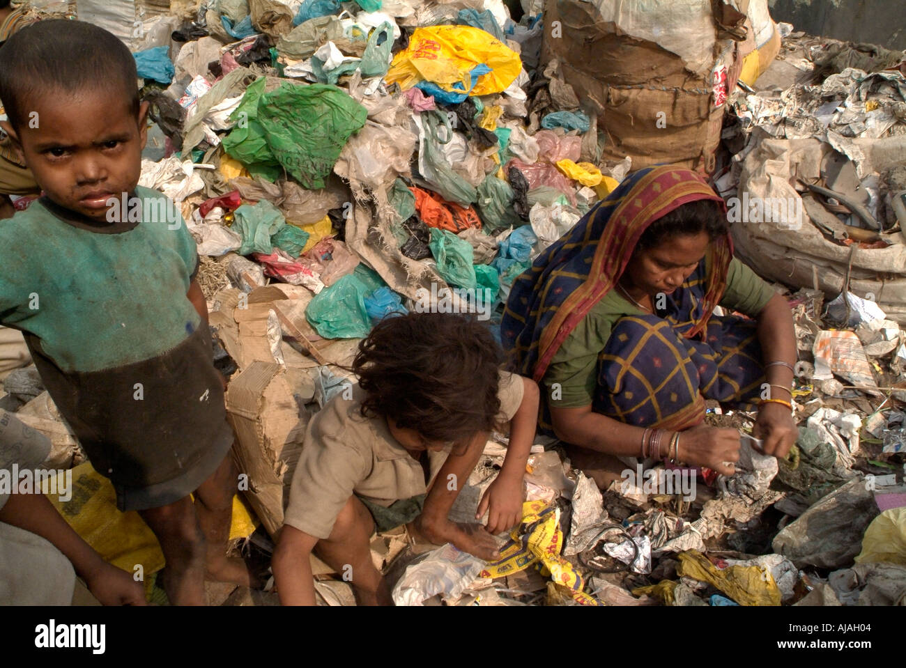 children working as rag pickers sorting out the garbage in a dump of