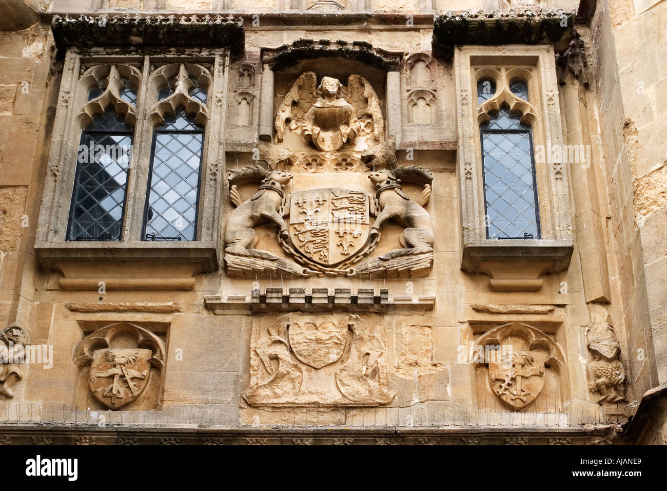 Coat of Arms and Weathered Stonework above The Penniless Porch in Wells Market Place Somerset England Stock Photo