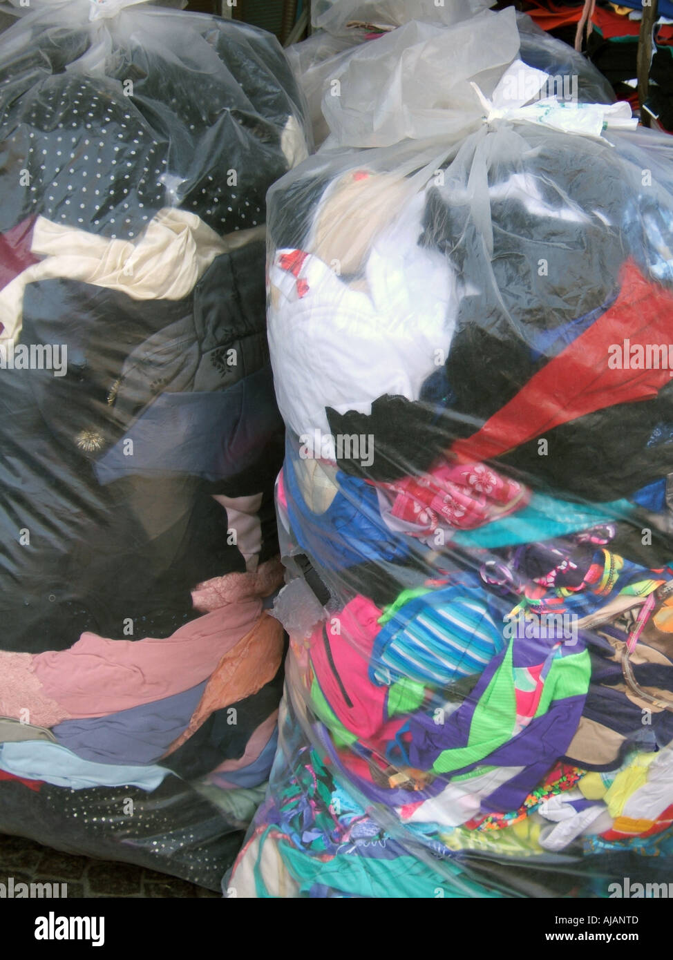 pile of clothes in plastic bags Stock Photo - Alamy