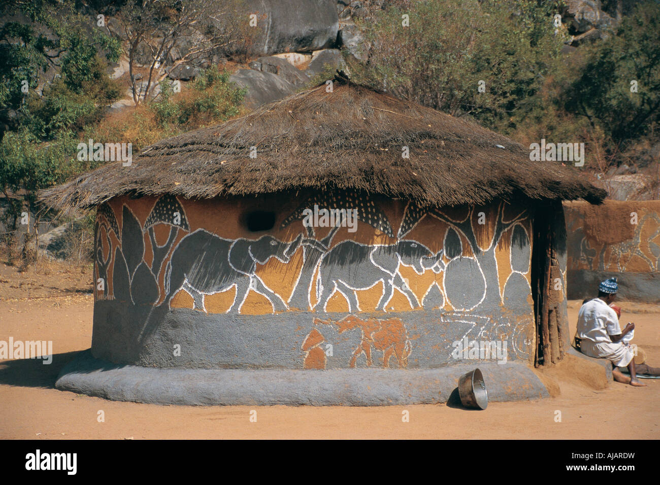 Traditional African hut with decorative painting and thatched roof in Matobo National Park Zimbabwe Stock Photo